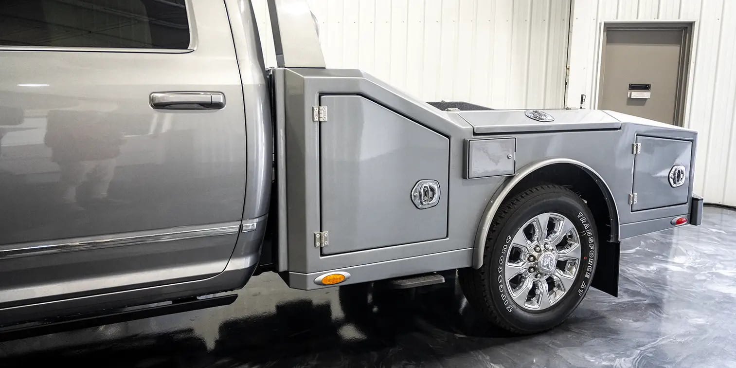 The exterior of a gray 2024 Dodge Ram 3500 offered by Luxe Trucks.